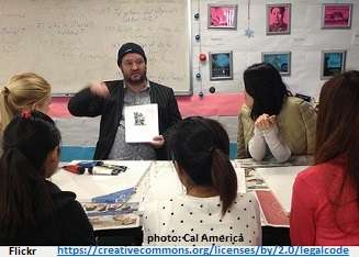 Teacher demonstrating an ESL picture activity to his class.