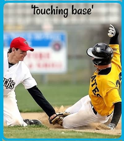 Baseball photo: a baseman touches a runner with the ball in his glove as the runner slides into a base. (The runner is 'touching base,' as the caption says.)