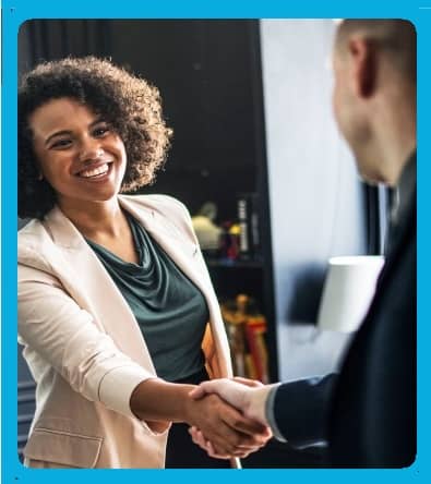 A young businesswoman shaking hands with a young man.