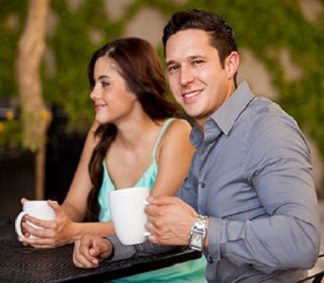 man and woman having coffee together and making small talk.