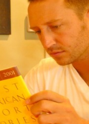 Young man reading a textbook