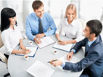 4 people around a table at a business meeting