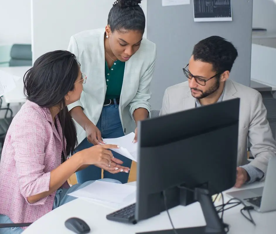 3 people discussing a project at work