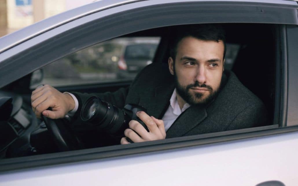 a spy at the wheel of a car