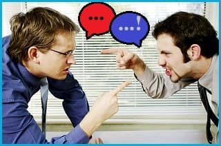 2 men having a fierce argument, pointing their fingers at each other. The man on the left has a red speech bubble above his mouth. The man on the right has a blue one.